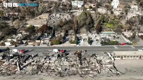 Picture of road with burned out houses on beachfront