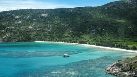 An aerial photo taken on April 4, 2024, shows a boat anchored near coral around Lizard Island on the Great Barrier Reef.