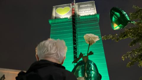 Balloons are let go from the bottom of Grenfell Tower, as dark falls