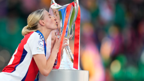 Chloe Kelly kisses the Women's Champions League trophy