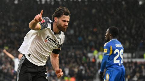 Ben Brereton Diaz waves his finger in the air as he celebrates scoring for Derby County against Leeds in the FA Cup