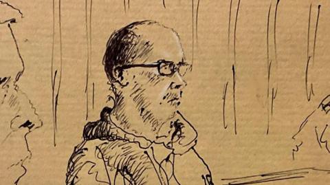 An artist's impression of Kinahan during his hearing on Sunday - sketch shows him wearing glasses, sat wearing a hooded jumper