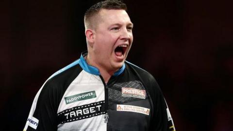 Chris Dobey celebrates winning his quarter-final against Gerwyn Price at the World Championship