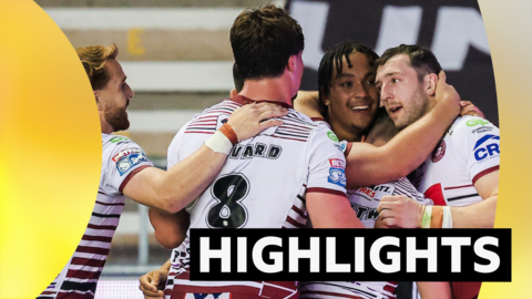Austin Daniel of Wigan celebrates with team-mates after scoring a try against Warrington