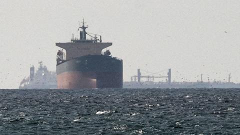 FILE PHOTO: Cargo ships in the Gulf, near the Strait of Hormuz, as seen from northern Ras al-Khaimah, near the border with Oman’s Musandam governance, amid the U.S.-Israeli conflict with Iran, in United Arab Emirates, March 11, 2026. 