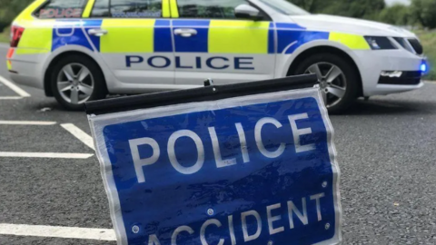 Police accident sign in front of police car.