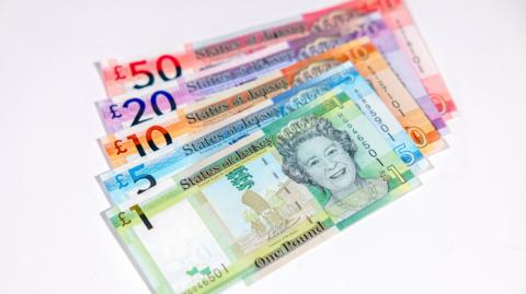 A stack of Jersey currency showing a notes including £1, £5, £10, £20 and £50.