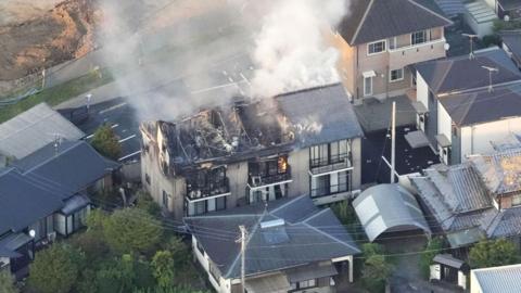 An aerial view shows a residential building on fire after an earthquake with a preliminary magnitude of 7.1 struck Japan's southern Kumamoto prefecture, in Yatsushiro, Kumamoto prefecture, Japan, July 28, 2026