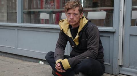 Rough sleeper Alex sitting in Wisbech town centre