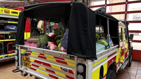 a fire truck with children's toys in the back