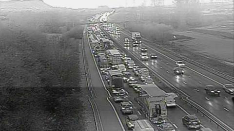 A CCTV image of traffic queuing on one side of the motorway