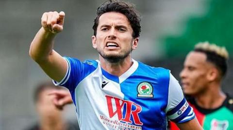 Blackburn skipper Lewis Travis points his finger and shouts during a match