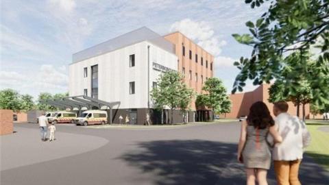 An artist impression of the centre- a grey building with two ambulances parked in front- and a couple and another man and child walking towards it 