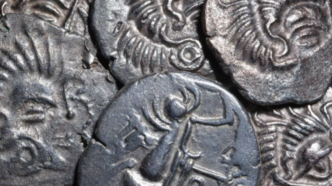 A close up of some of the silver coins showing intricate designs. 