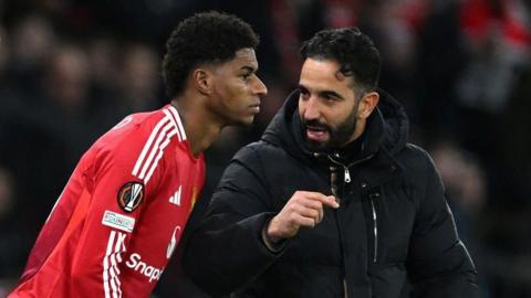 Manchester United manager Ruben Amorim talking to Marcus Rashford