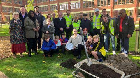 People burying time capsule