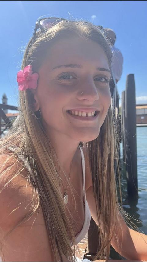 A young girl smiling towards the camera