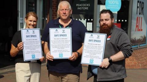 Three people holding up signs for safe spaces in the Nottinghamshire borough of Rushcliffe.