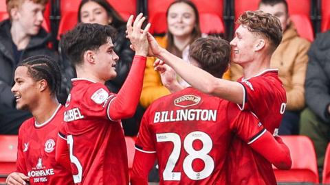 Connor O'Riordan of Crewe Alexandra (right) celebrates his goal with team-mates