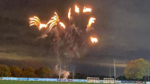 A fireworks display over a rugby field.