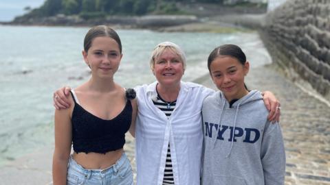 Lillia, Sue and Juliette standing on Havelet Slip way hugging 