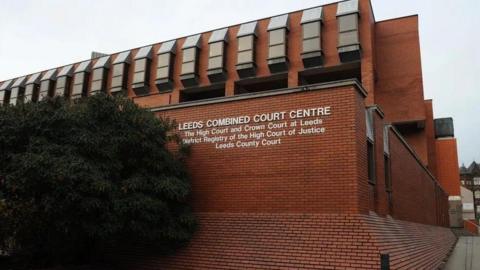 The outside of Leeds Combined Court Centre, a relatively modern brick building.