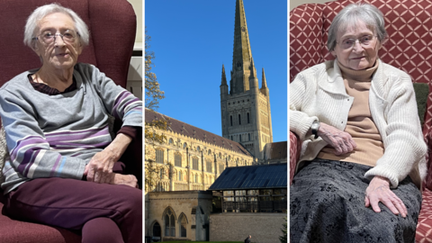 A composite image of three photographs, from left to right: A woman wearing a grey jumper, glasses and maroon trousers sits on a similarly coloured chair, Norwich cathedral on a sunny day in the centre and on the right, a woman wearing glasses sits on a red patterned chair wearing a grey skirt and cream cardigan
