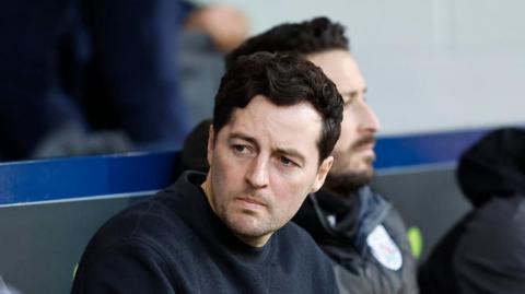Ryan Mason looking at the match action while sat in the dugout