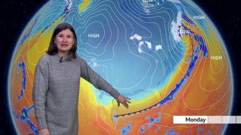 Helen Willetts stands in front of a weather map of the US