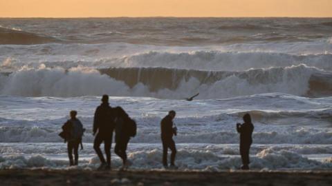 Beachgoers watch massive waves in San Francisco, California this week