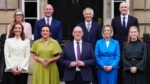 John Swinney and his cabinet stand on the steps of Bute House