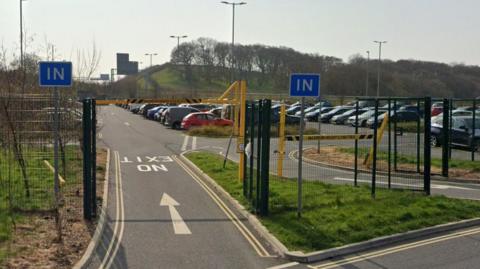 Lancaster's park-and-ride site is a large, fence-enclosed car park behind two gates.