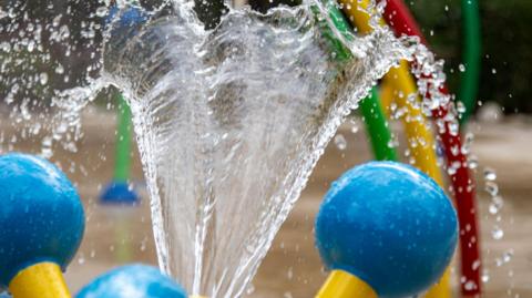 Water spraying out of a fountain in a municipal park