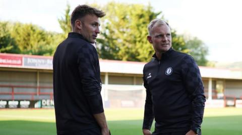 Bristol City assistant head coach Chris Hogg (left) standing with Liam Manning (right)