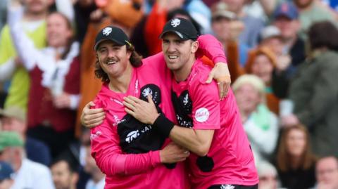 Somerset's Tom Kohler-Cadmore and Craig Overton celebrate the wicket of Lancashire Lightning's Tom Hartley
