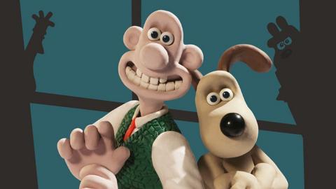 Wallace and Gromit standing back to back in front of a window with shadows of their enemies
