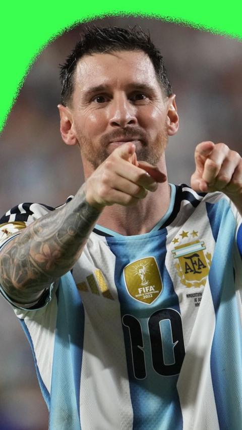 Argentina captain Lionel Messi celebrating a goal. He is wearing an Argentina home shirt.