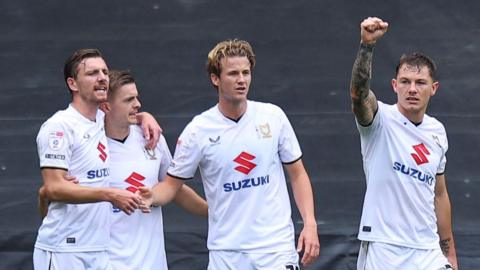 Callum Hendry celebrates scoring MK Dons' winner against Walsall