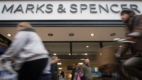 People walking past a Marks & Spencer store