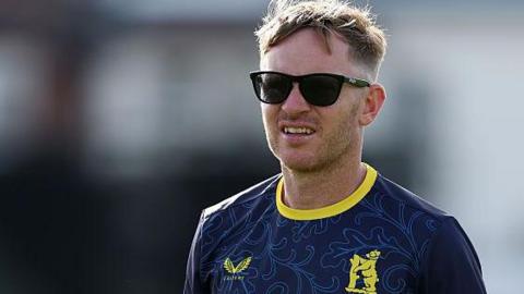 Ian Westwood takes a training session in his navy blue Warwickshire tee-shirt. He is wearing sunglasses.