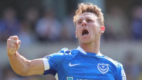 Adrian Segecic of Portsmouth celebrates scoring their first goal during the Championship match between Oxford United 