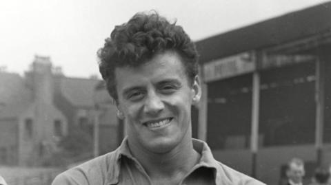 Peter Higham head shot black and white with 1950's football shirt