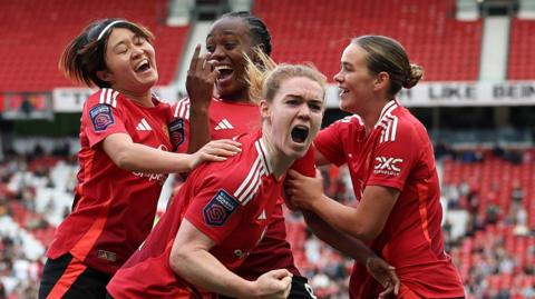Manchester United players celebrate Melvine Malard's goal