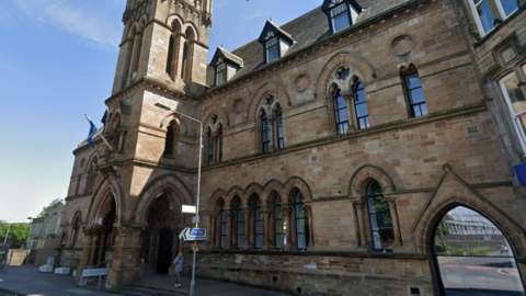 West Dunbartonshire Council offices - a large sandstone building with a tower as part of it.