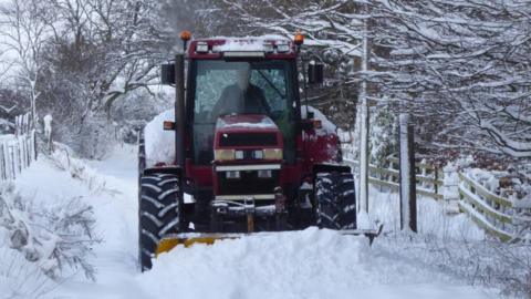 A tractor is seen on heavy snow