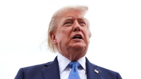 President Donald Trump speaks to reporters before boarding Air Force One.
