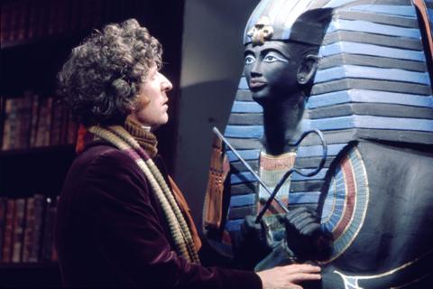 The Fourth Doctor looks into the face of an Egyptian sarcophagus 