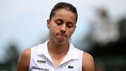 Maja Chwalinska grimaces after falling during her Wimbledon first-round match