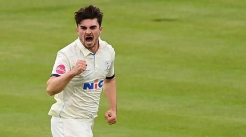 Jordan Thompson punches the air in celebration after taking a wicket for Yorkshire
