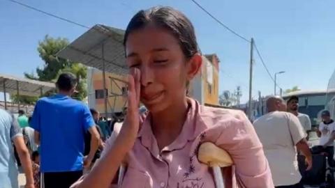 Sara Marzouk wipes away a tear as she waits to join a medical evacuation out of Gaza (30/07/24)